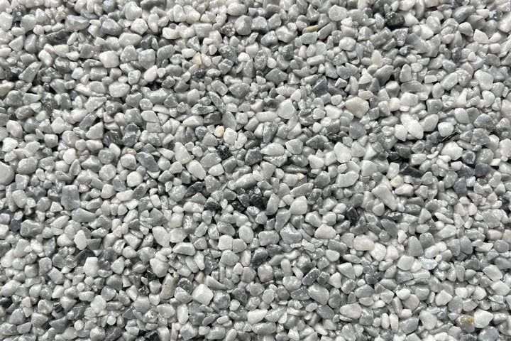 A dense texture of small, rounded gray and white pebbles.