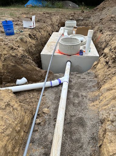 A septic tank is being installed in a hole in the ground.