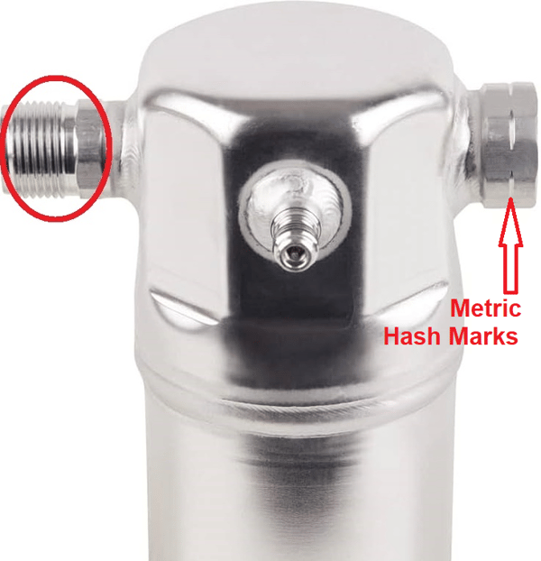Chrome plumbing fitting with threaded side ports; one port is circled and labeled metric hash marks.