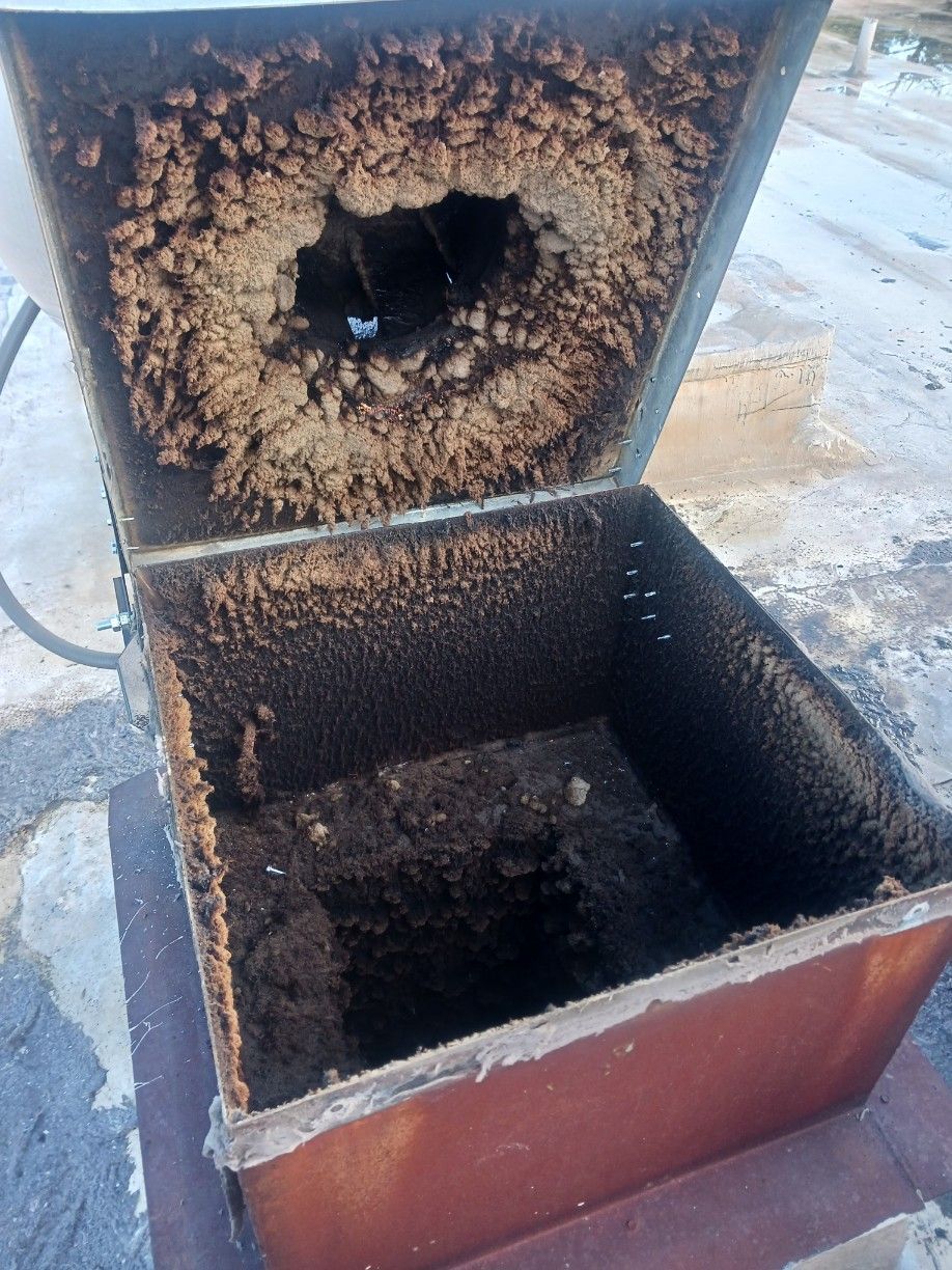 A dirty box with a hole in the middle of it.