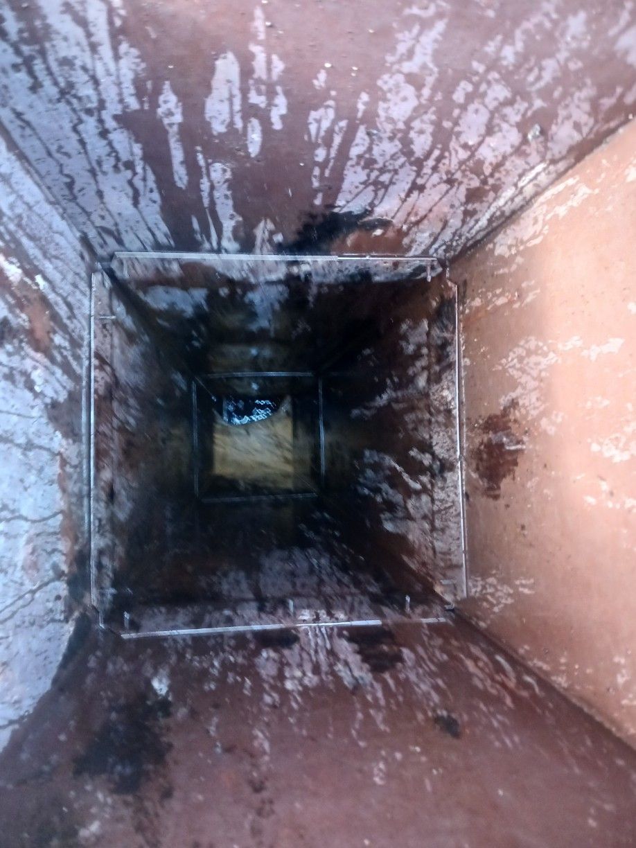 A person is looking down a hole in a wall.