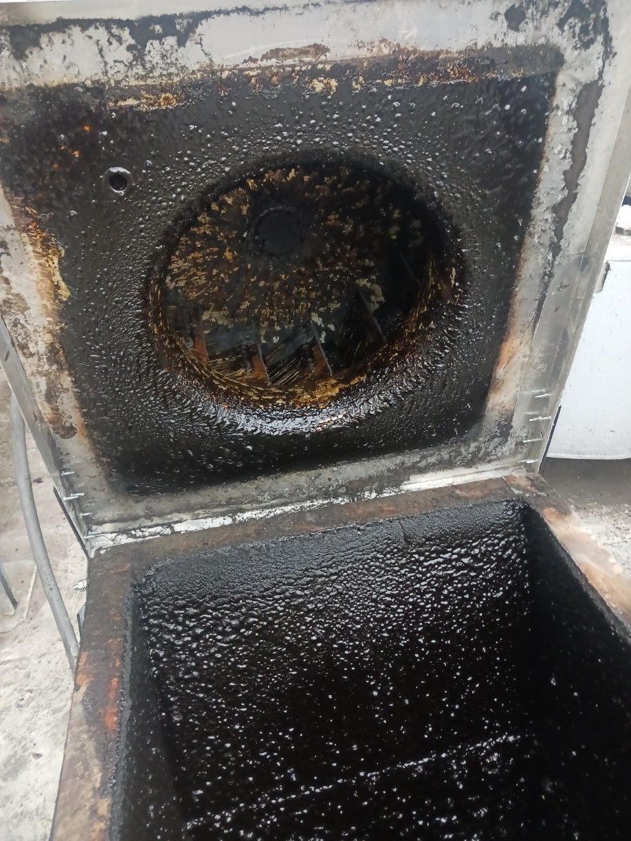A close up of a dirty stove with the lid open.