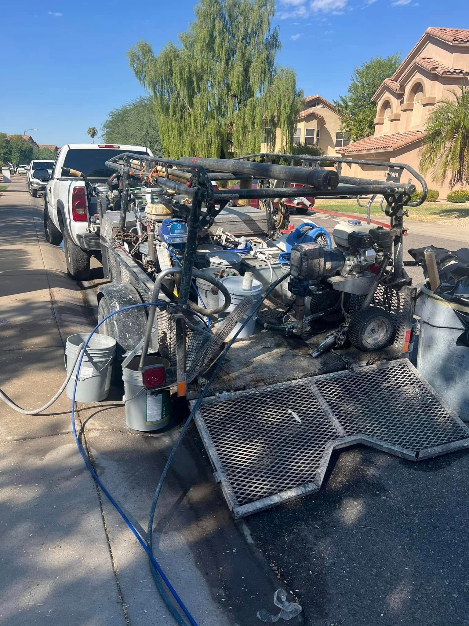 A truck is towing a motorcycle down a street.