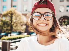 A man with a beard is holding his face in pain.