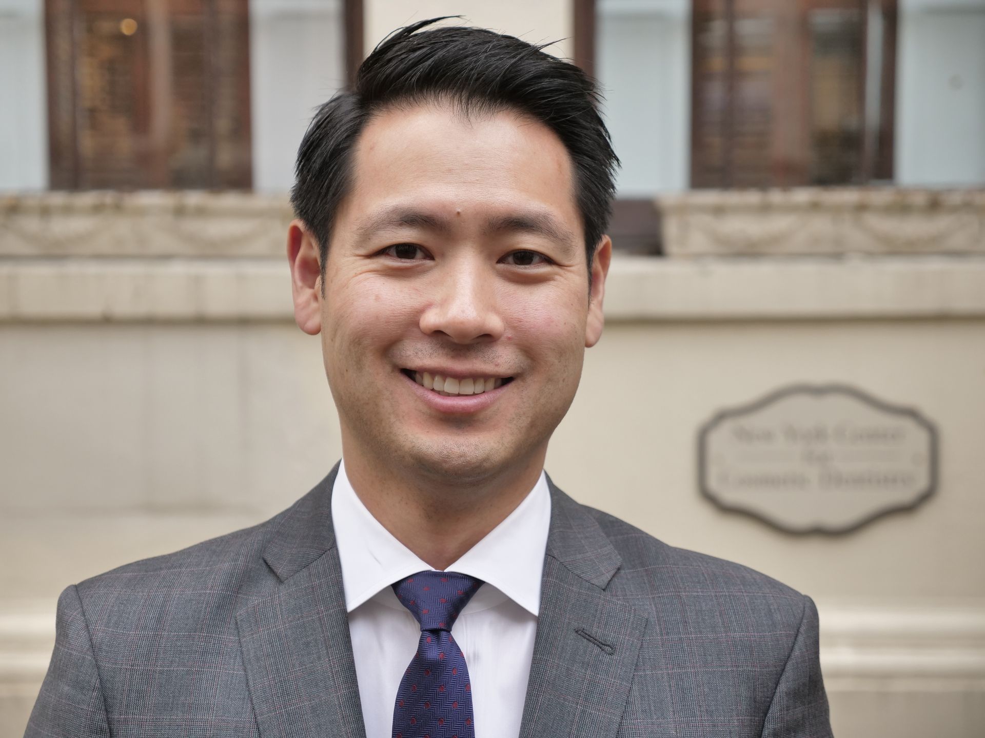 A man in a suit and tie is smiling for the camera. the man is garden city dentist 