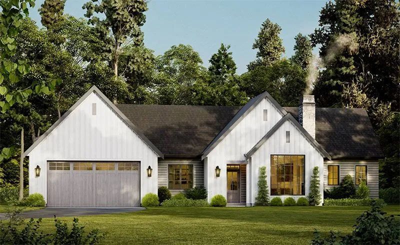 Modern white farmhouse with gray roof, garage door, and chimney; lush green lawn, trees in the background.
