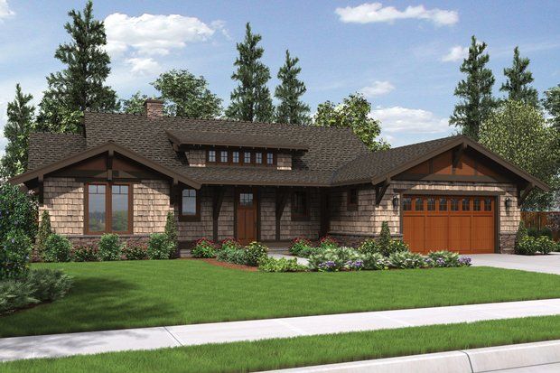 Craftsman-style house with brown wood accents, stone facade, and a green lawn.
