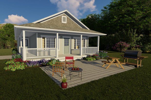 Small gray cottage with a porch, patio furniture, and a grill on a sunny day.