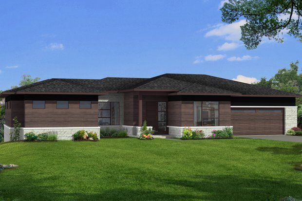 Modern, single-story house with brown siding, flat roof, garage, and manicured lawn under a blue sky.