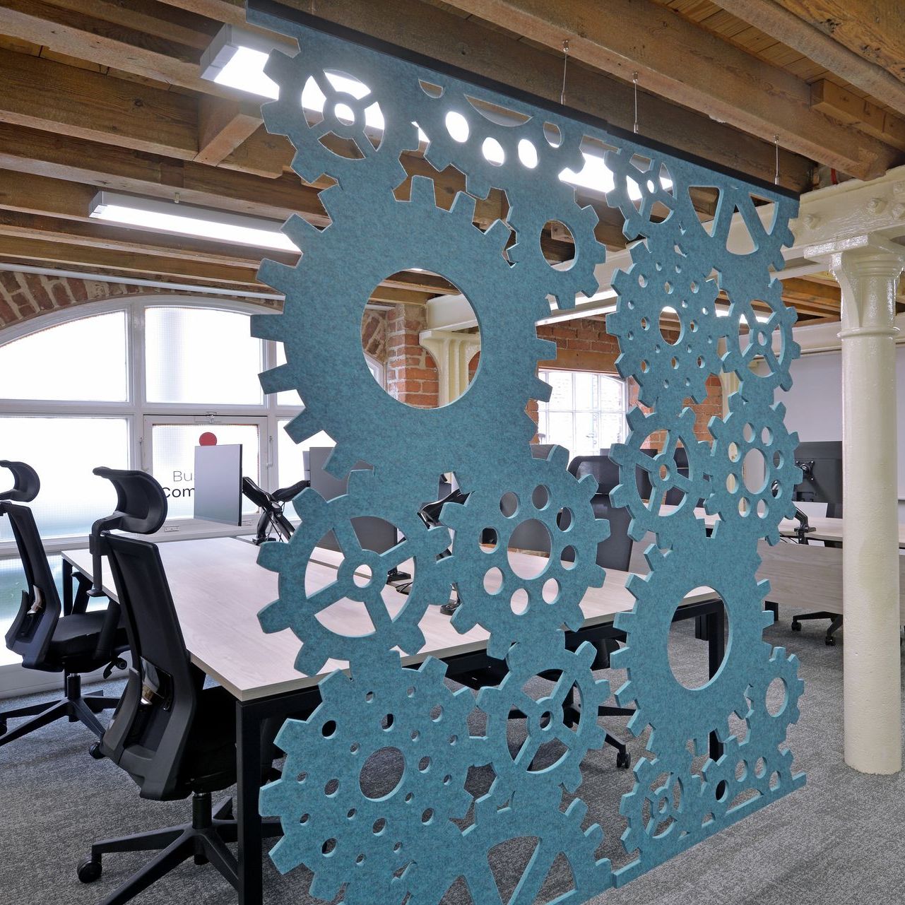 meeting space with branded wall of cogs