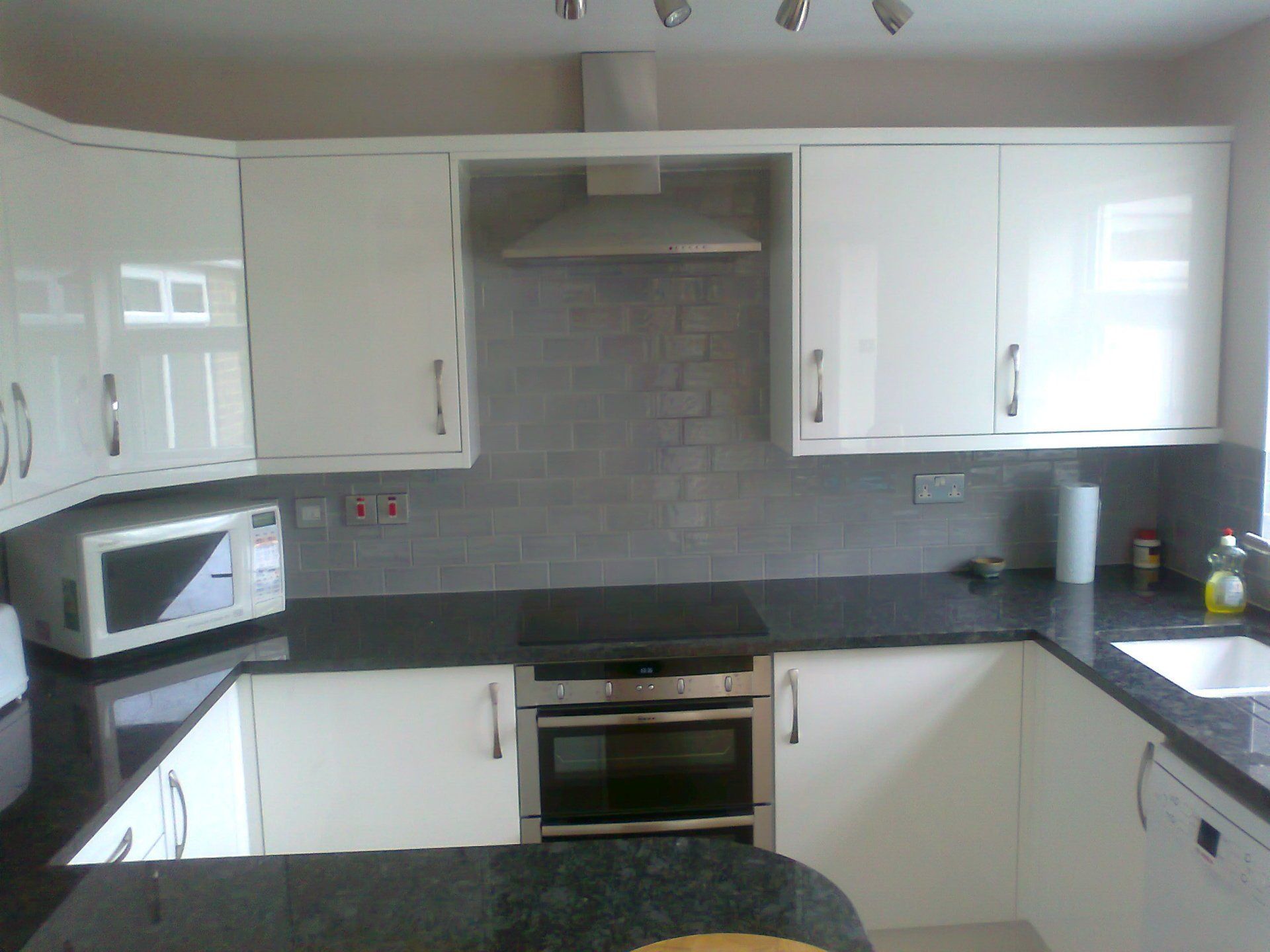 kitchen gloss white black granite worktop grey brick tiles kitchen