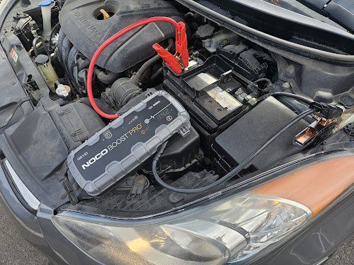 A car engine with a jump starter attached to it.