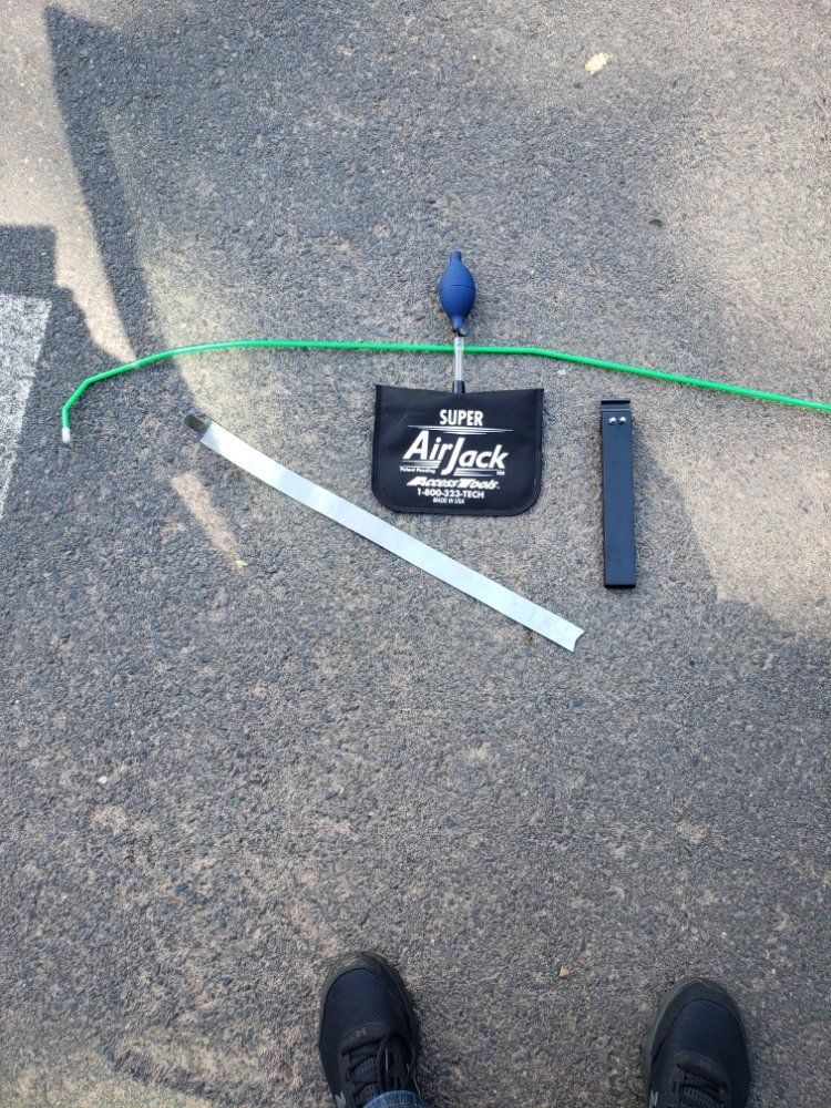 A person is standing next to a tool on the ground.