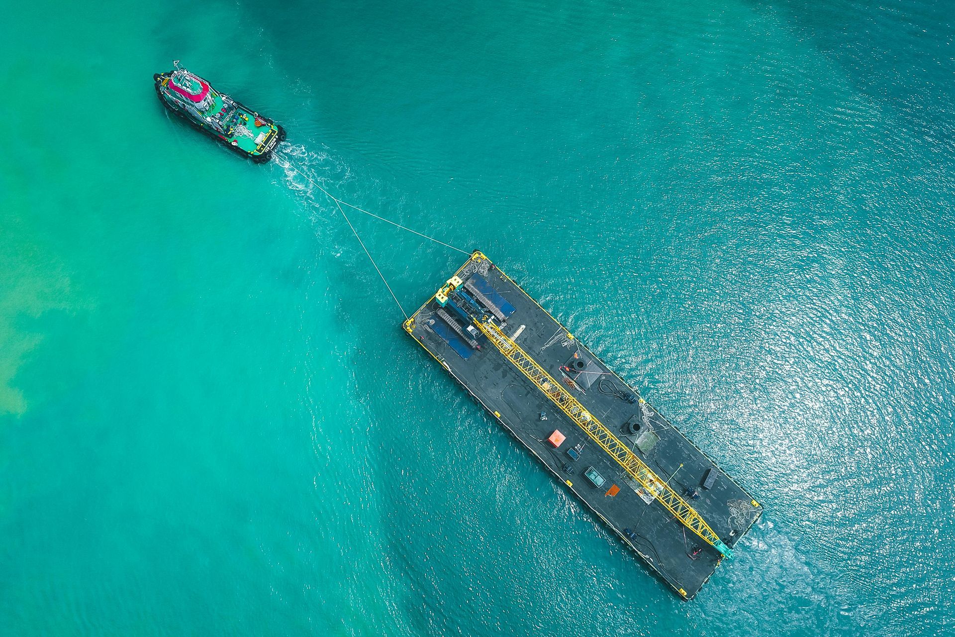 An aerial view of two ships in the ocean.