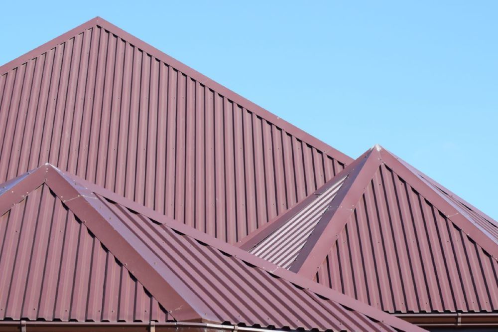 A Close Up of a Red Roof With a Blue Sky in the Background — Timms Roofing In Barrack Heights, NSW