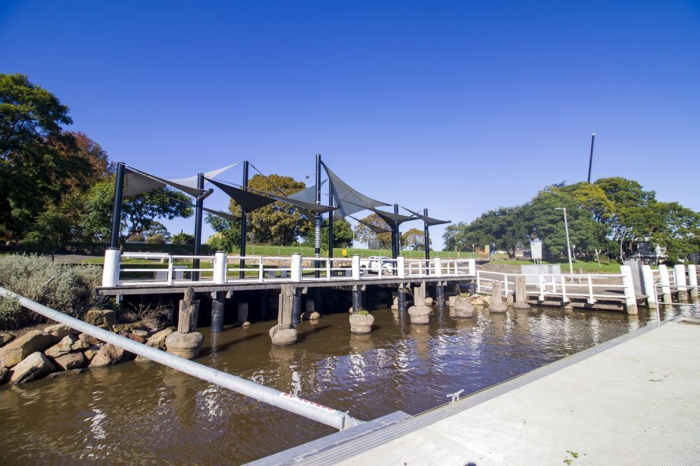 A Bridge Over a River With Trees in the Background — Timms Roofing In Nowra, NSW