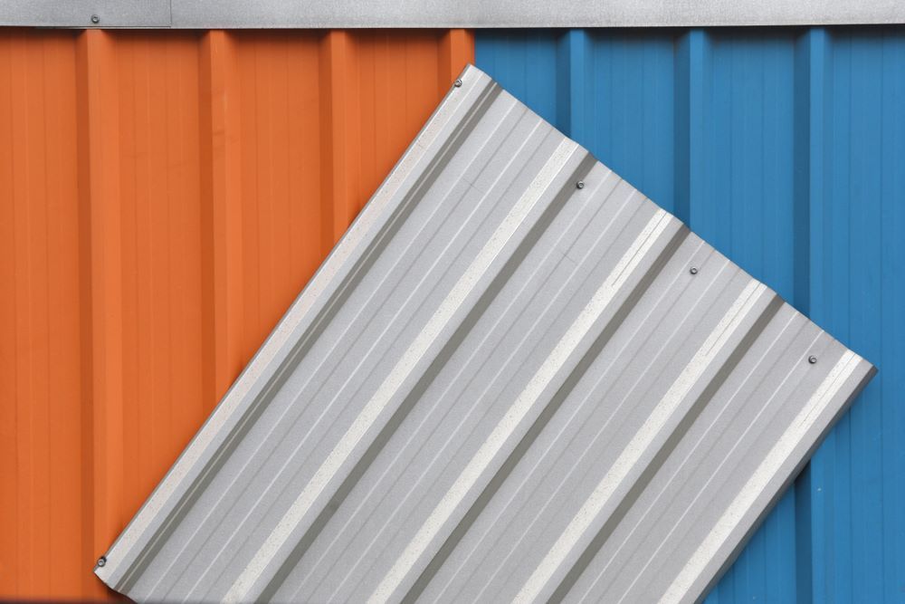 A Close Up of Two Different Colored Metal Sheets on a Wall — Timms Roofing In Nowra, NSW