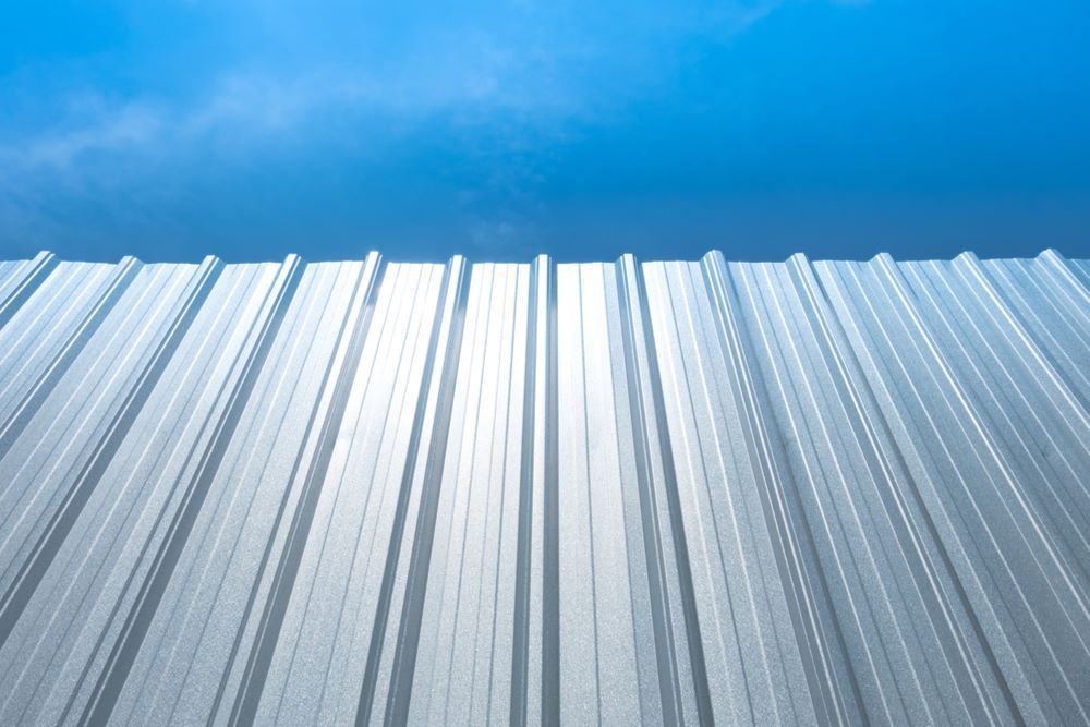 A Close Up of a Metal Roof With a Blue Sky in the Background — Timms Roofing In Barrack Heights, NSW