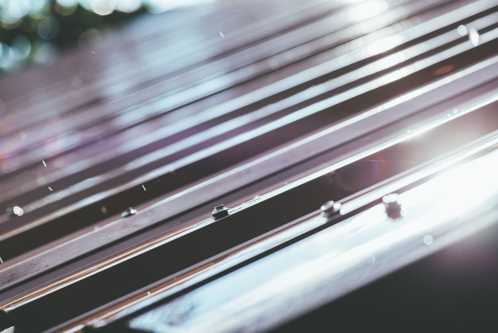 A Close Up of a Metal Railing on a Train Track — Timms Roofing In Shellharbour, NSW