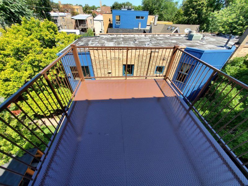 A balcony with a railing overlooking a city