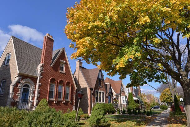 The roof of a house in a residential area with a lot of houses in the background.