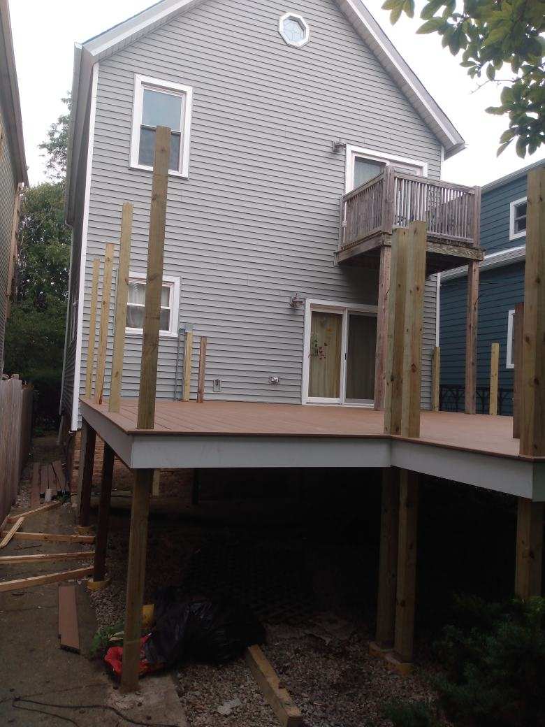 A house with a wooden deck in front of it