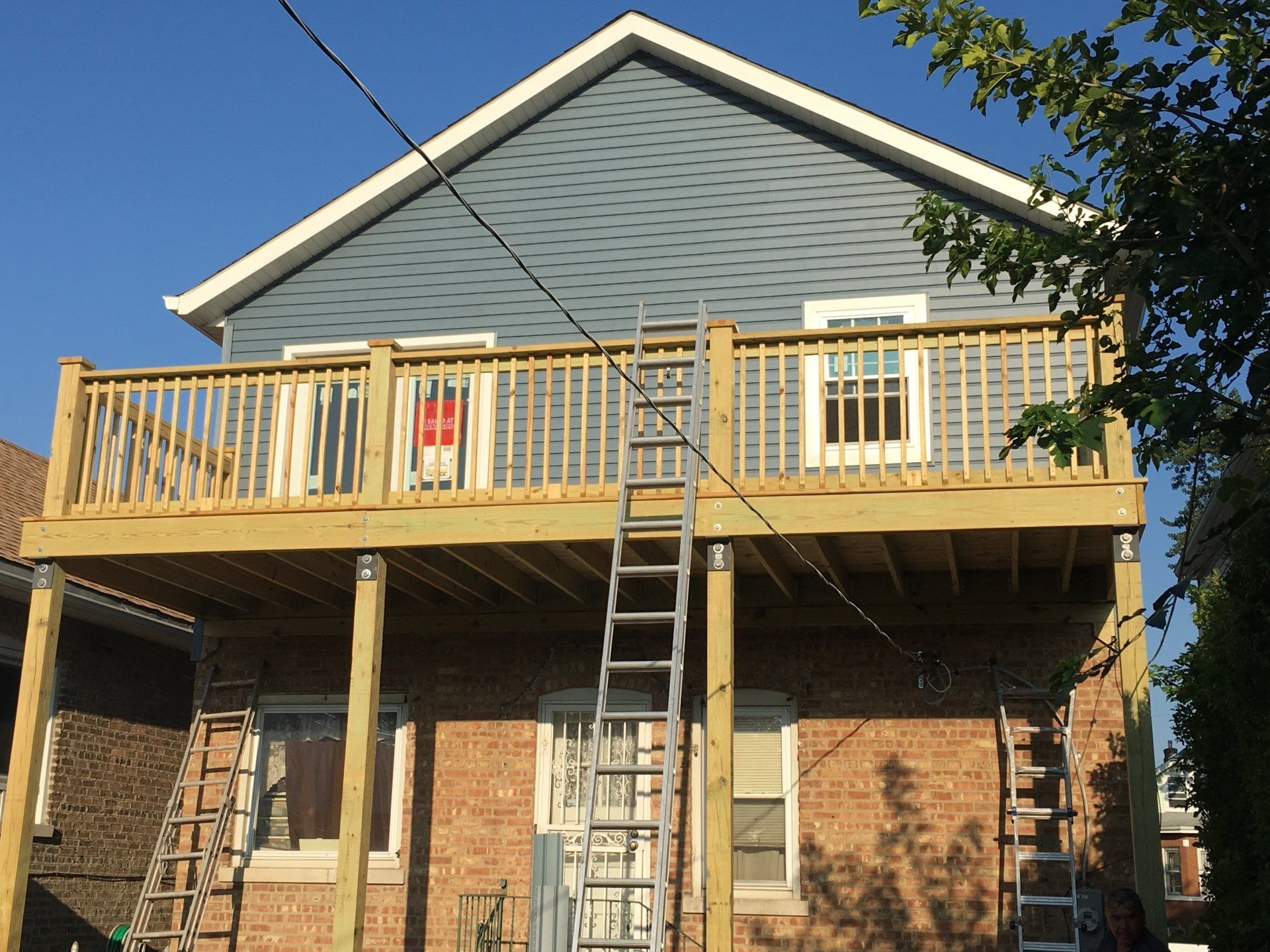 A house with a wooden deck on top of it