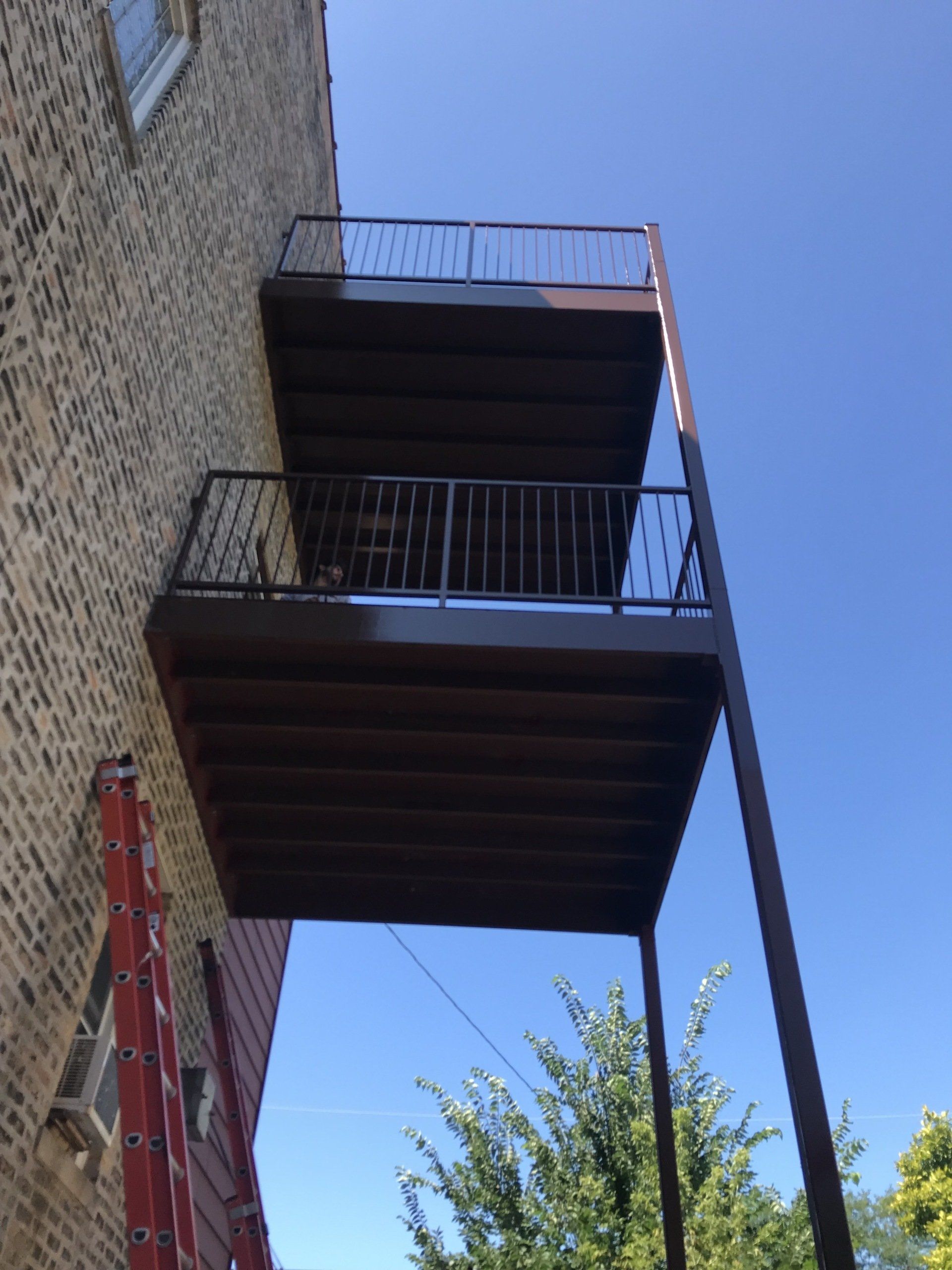 A balcony on the side of a brick building