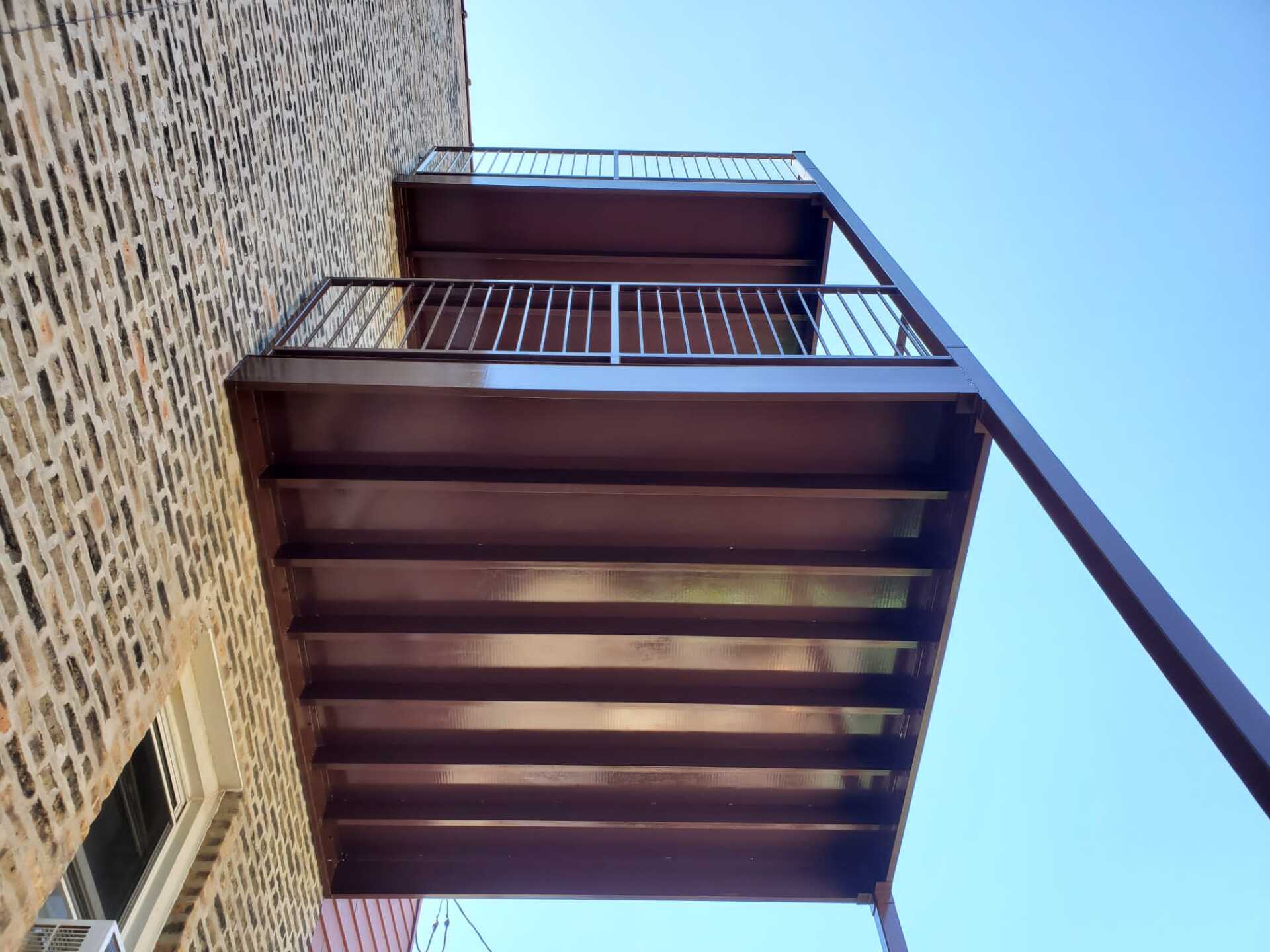 A fire escape is attached to the side of a building