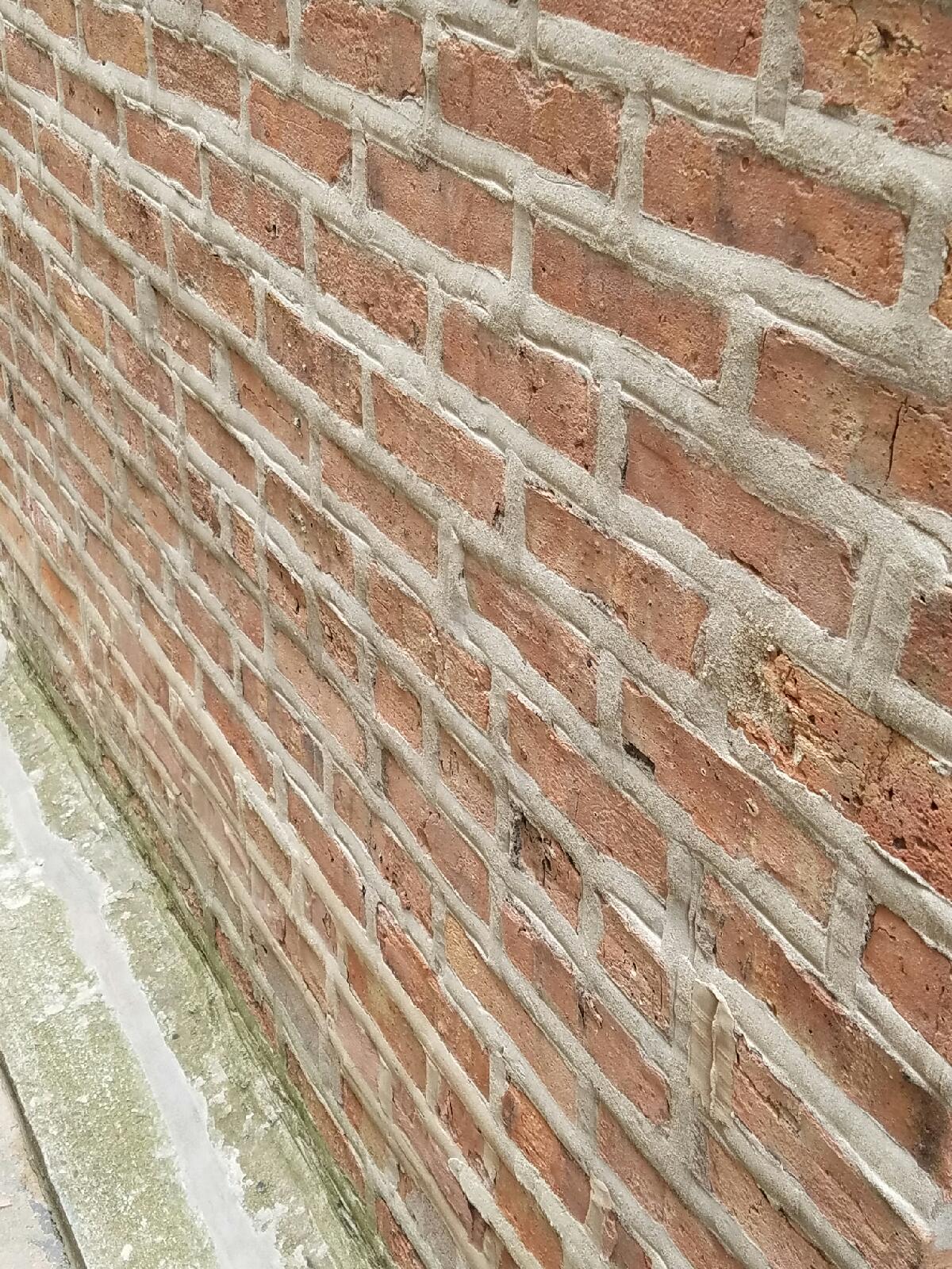A close up of a brick wall with a lot of bricks.