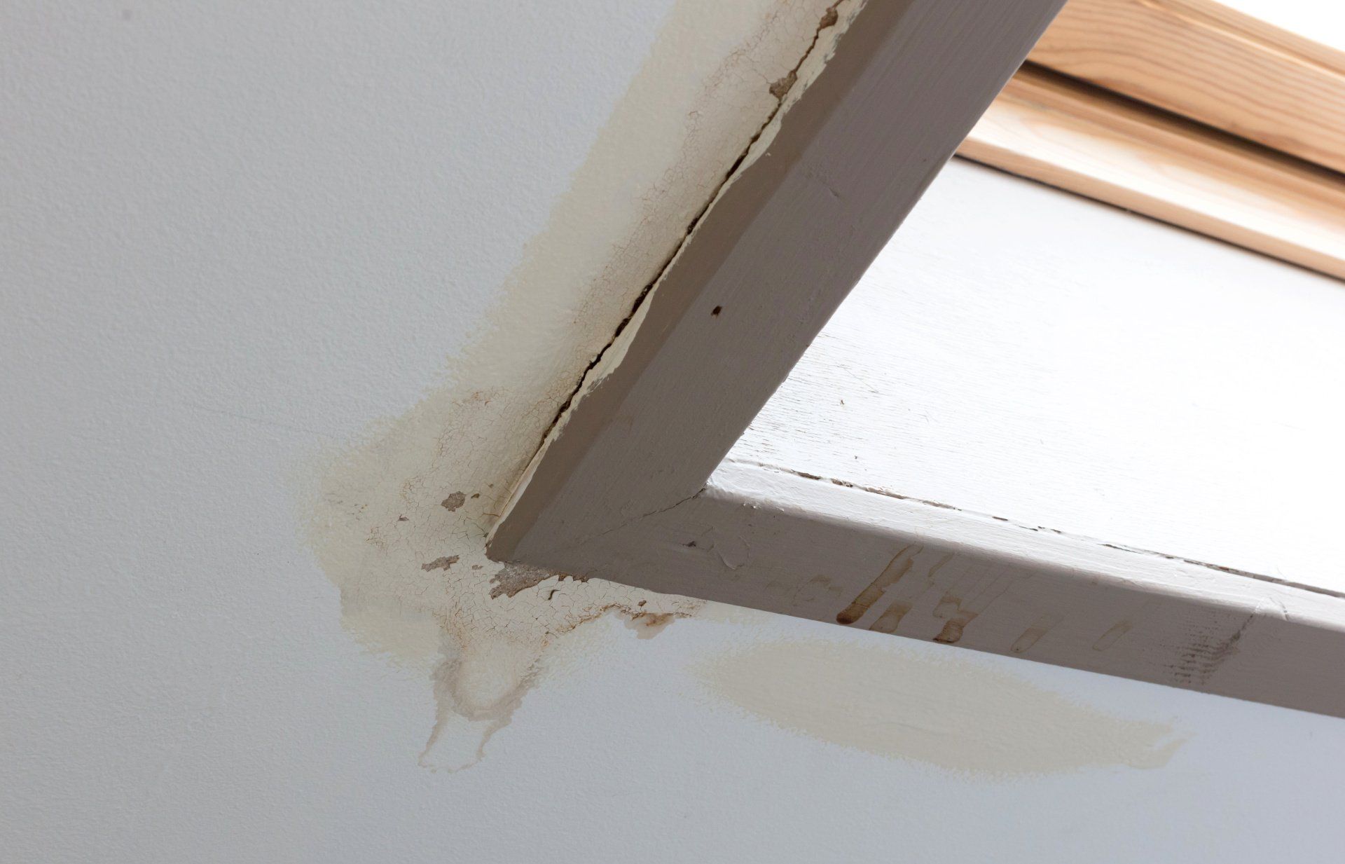 A corner of a window with a stain on it