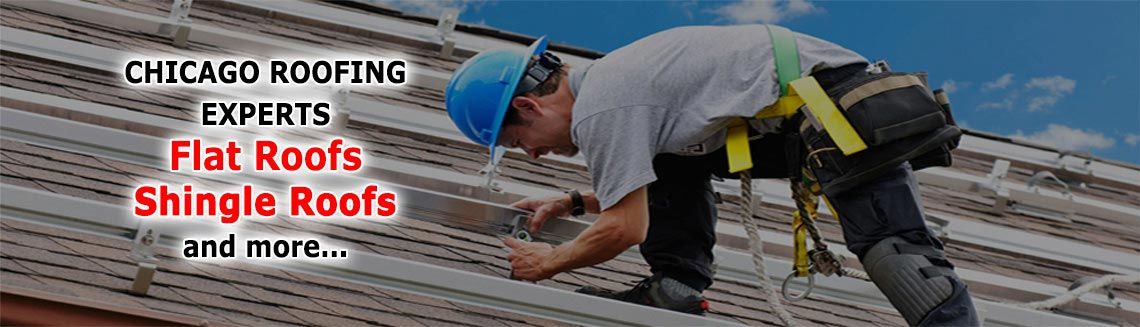A man wearing a hard hat is working on a roof.