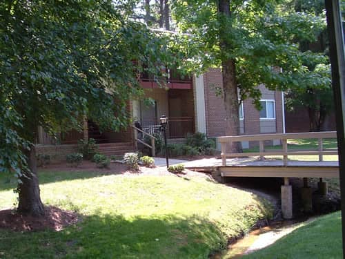 Two-story, brick apartment buildings surrounding by trees