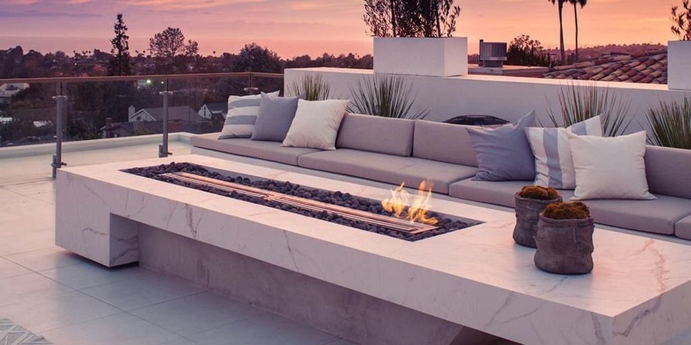 A patio with a fire pit and a couch
