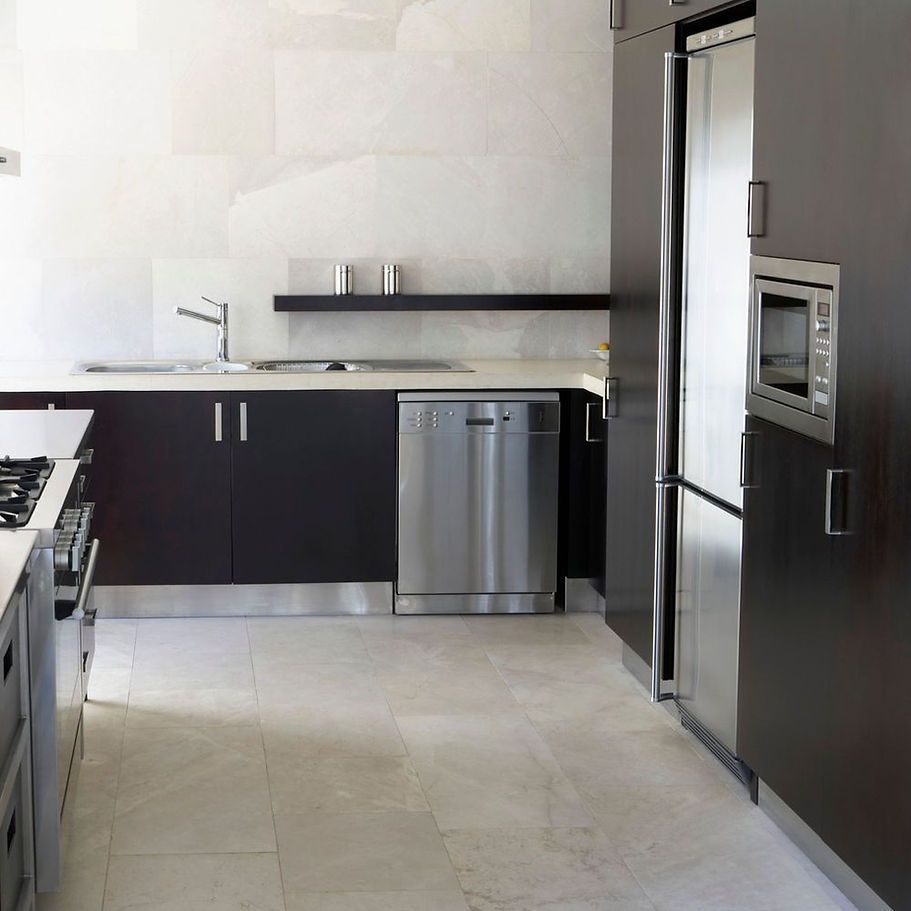 A kitchen with stainless steel appliances and black cabinets