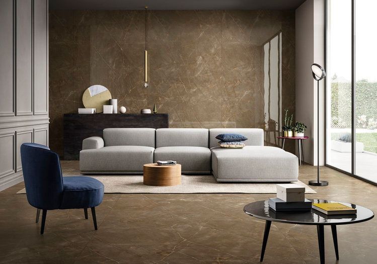 A living room with a couch, chair, coffee table and large windows