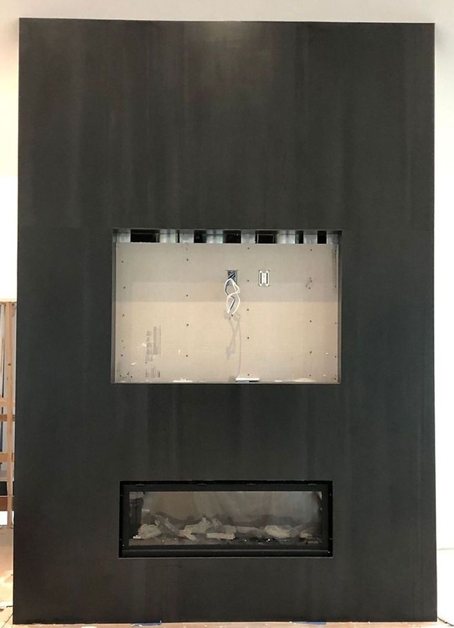 A fireplace with a flat screen tv mounted to the wall