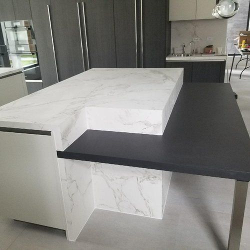 A kitchen with a large island and a black table