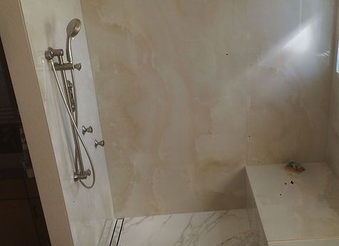 A bathroom with a walk in shower and a bathtub