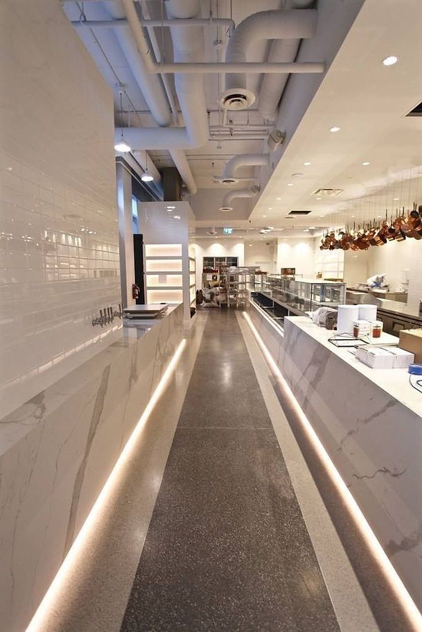 A long hallway leading to a counter in a restaurant