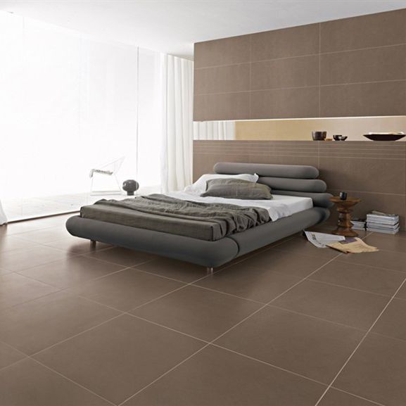 There is a large bed in the middle of the room