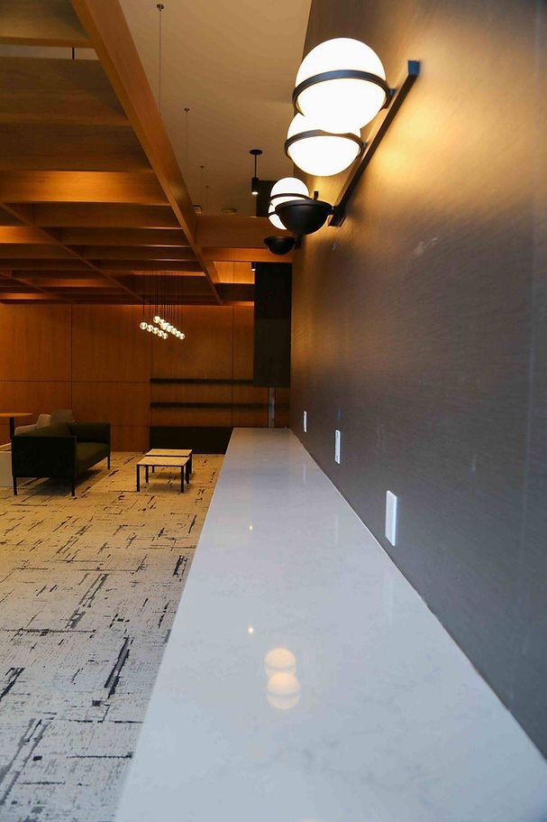 A long white counter in a room with a couch and a table