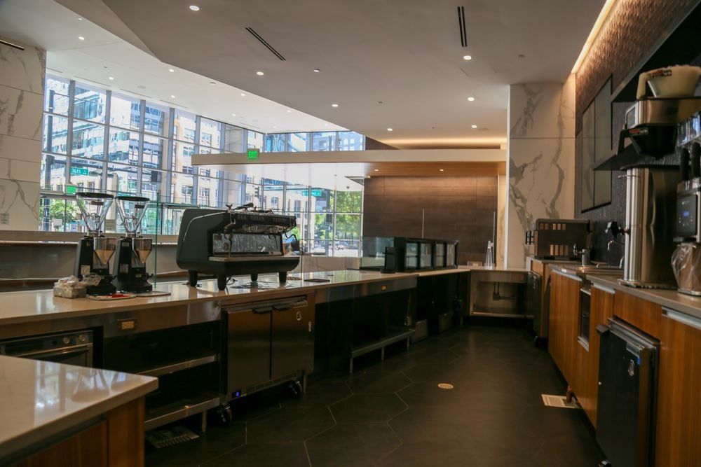 A kitchen with a lot of appliances and a large window