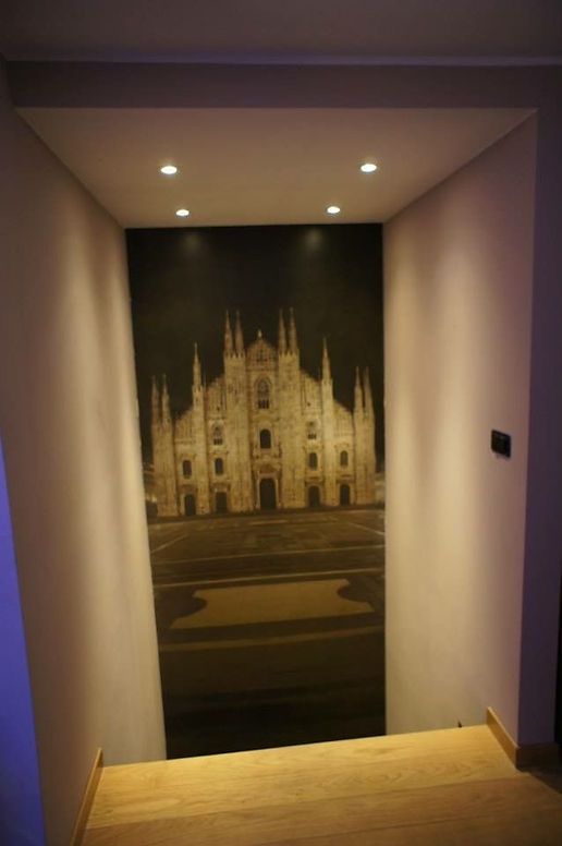 A hallway with a picture of a cathedral on the wall