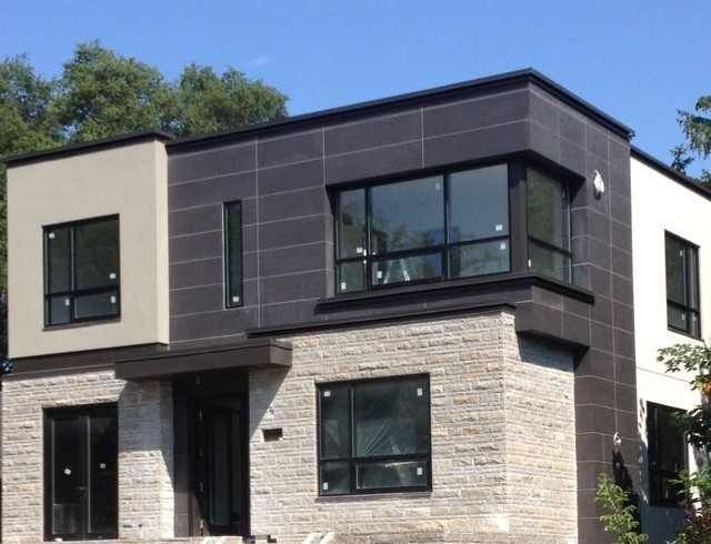 A house with a lot of windows and a blue sky in the background