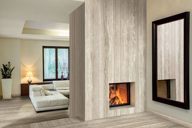 A living room with a fireplace and two mirrors