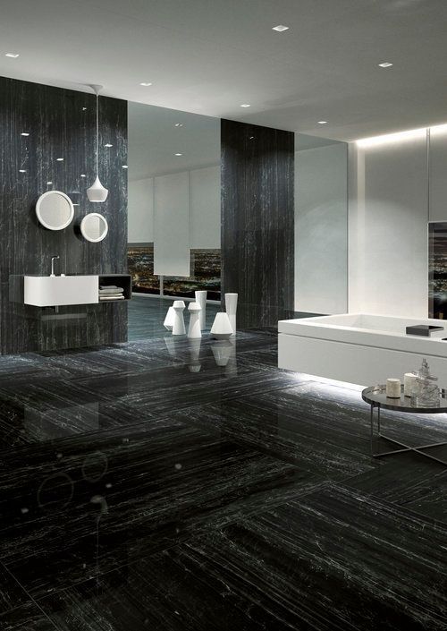 A bathroom with a bathtub, sink and mirrors