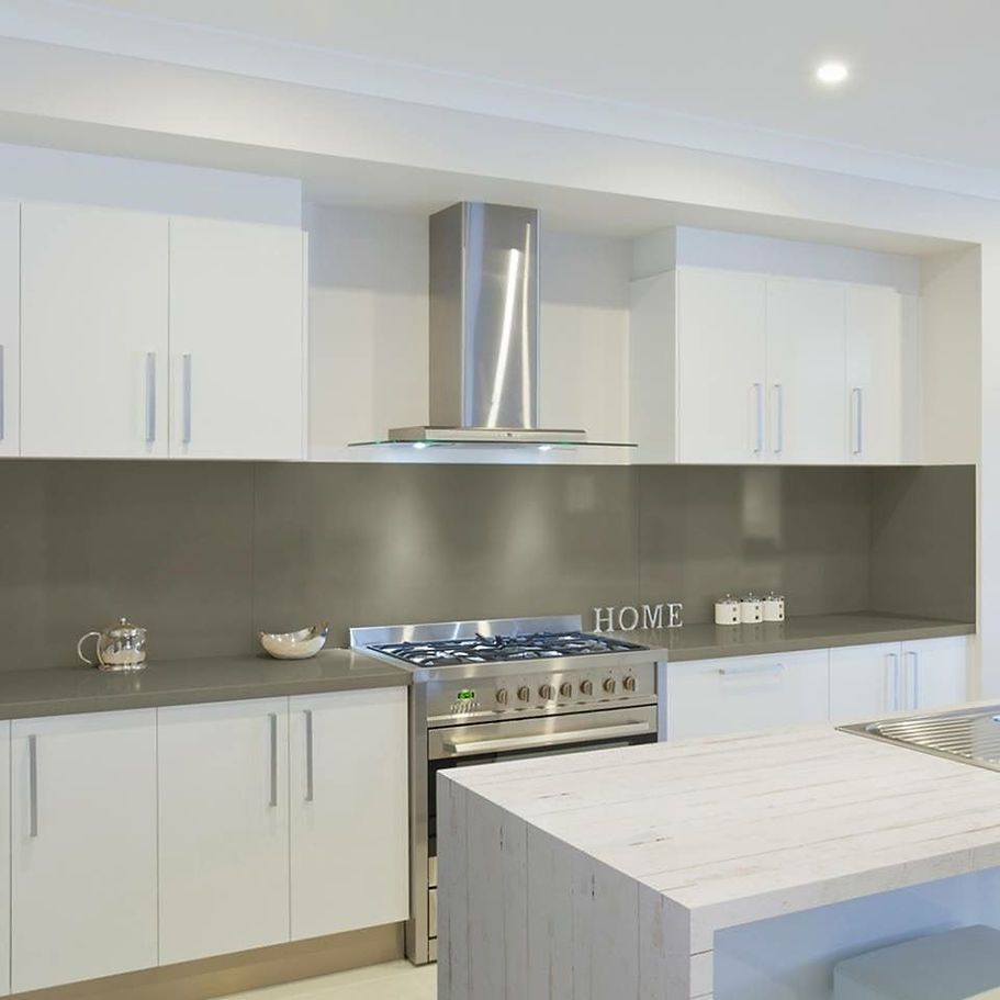 A kitchen with a stove top oven and a sign that says home