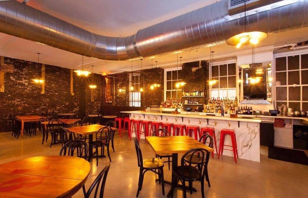 A restaurant with tables and chairs and a bar