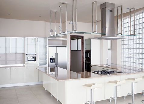 A modern kitchen with white cabinets and stainless steel appliances